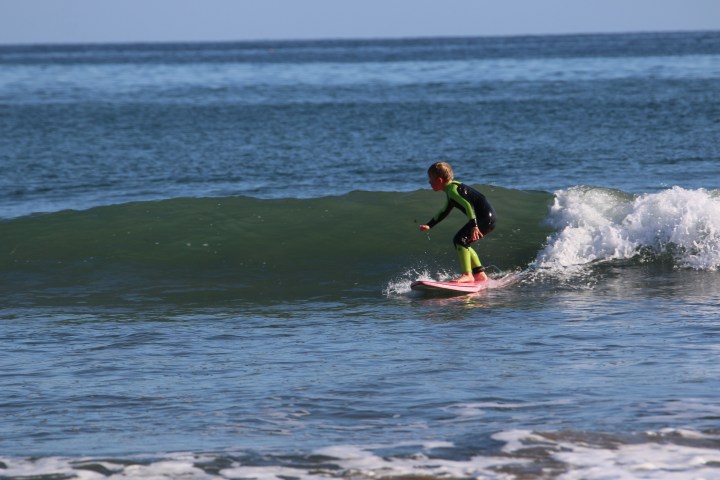 a man riding a wave on a surfboard in the water